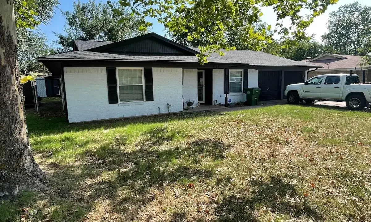 Professional roofing crew working on a residential roof in Grand Blanc
